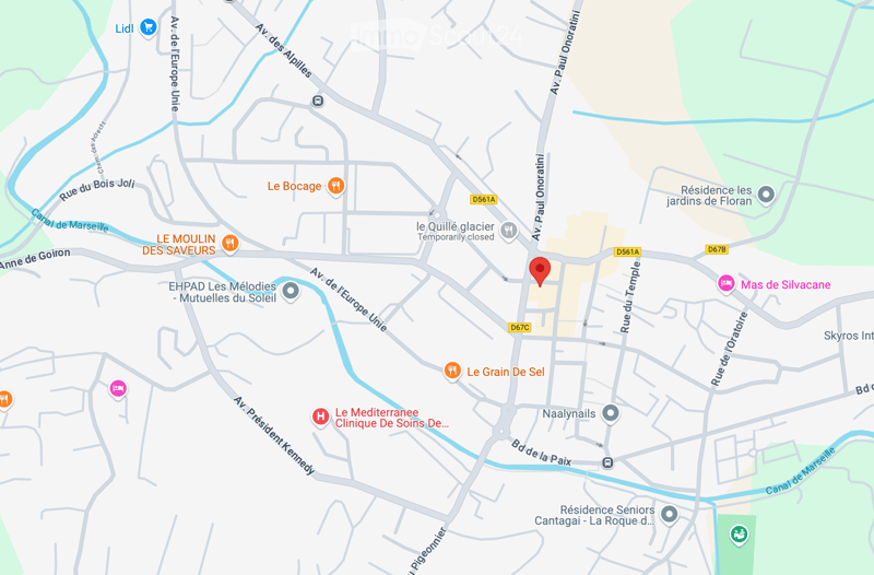 A map of an area with various buildings and landmarks, one building is highlighted with a pin indicating an address.