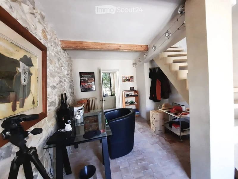 stone wall, glass table, chair, staircase, picture, shelves, radiator, items