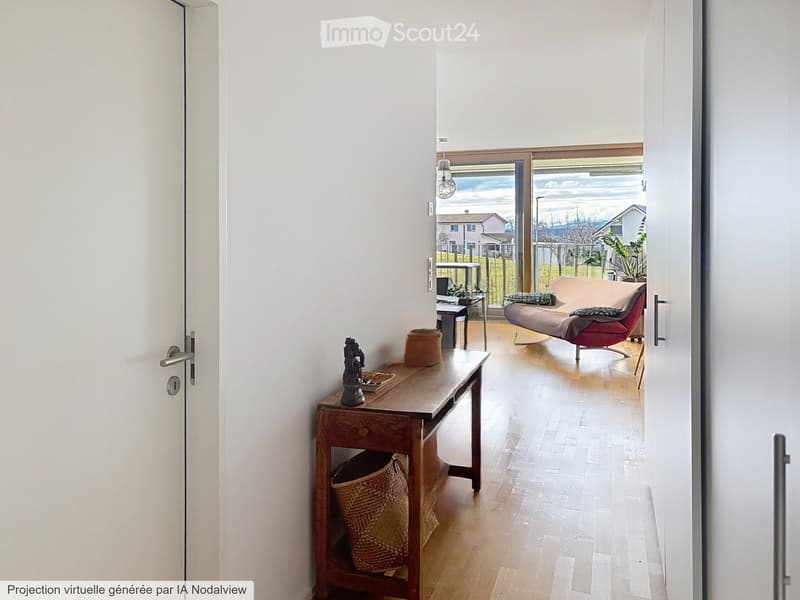 A modern, well-lit living space with a wooden floor, a small wooden table with a wicker basket and decorative items, a red sofa, and a view of a balcony area with outdoor furniture.