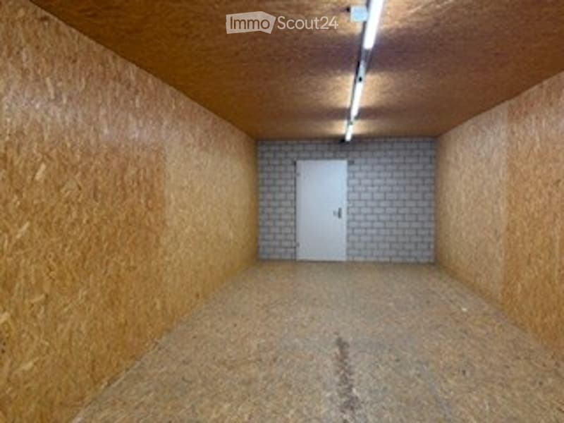 empty room, white door, brick wall, wooden ceiling, wooden floor