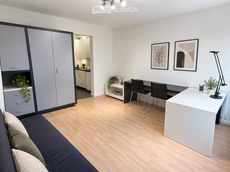Modern, well-lit room with a sofa, desk, and cabinet. Features a light wooden floor, white walls, and decorative plants.