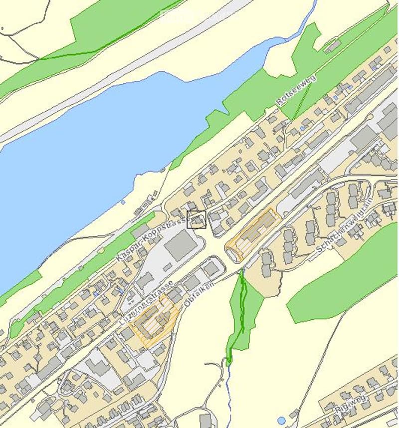 Topographic map showing a detailed layout of a town or city area, including streets, buildings, water bodies, and green spaces.
