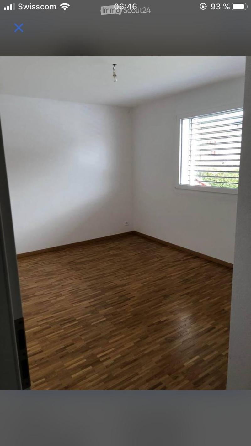 Empty room with wooden flooring, white walls, and a single window with blinds. No furniture or equipment present.