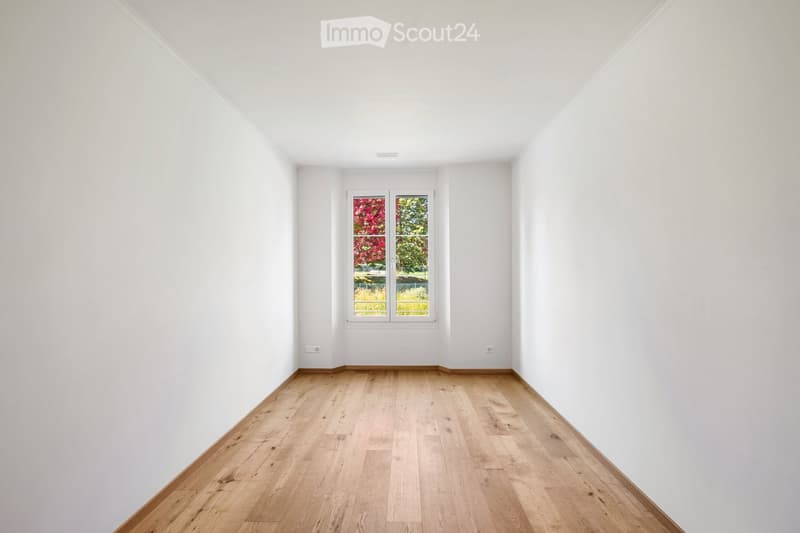 Completely empty room with bare white walls and light wooden flooring. No furniture or equipment.