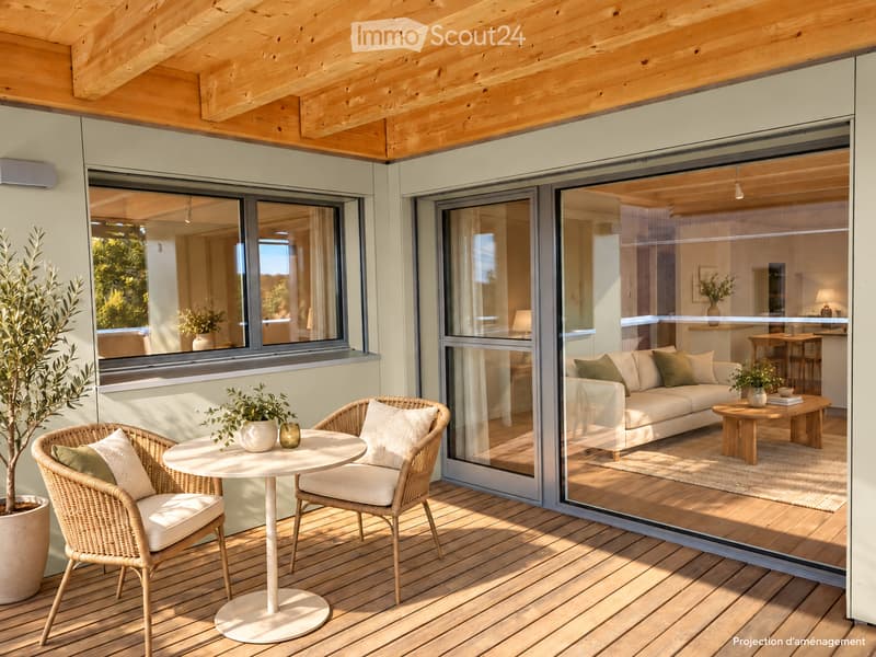 A modern wooden balcony with a white table, two wicker chairs, and a potted plant. Large glass doors open to a living room with a white sofa, coffee table, and additional seating.