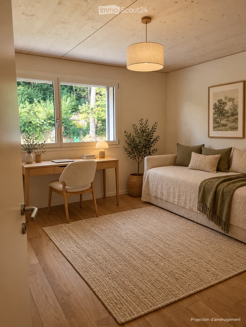 Cozy bedroom with a sofa, a wooden chair, a small table with a lamp, a large woven rug, and a framed picture on the wall. The room features wooden flooring and large windows with a view of greenery.