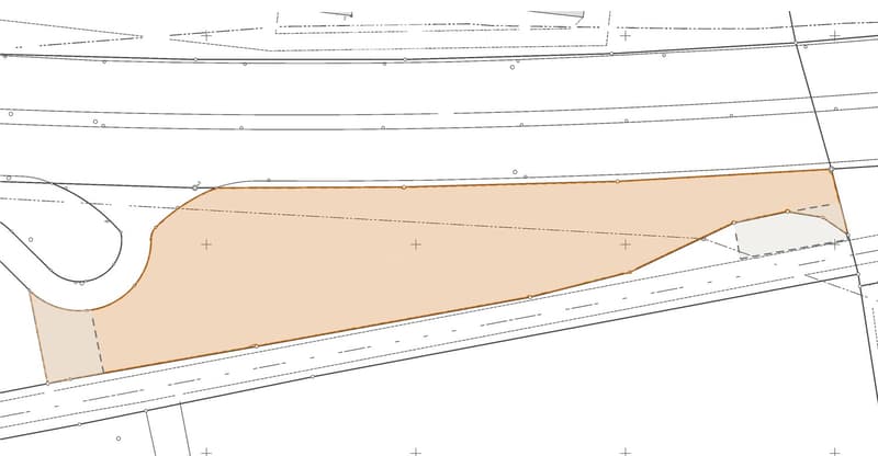 Floor plan showing a large rectangular area with a curved section on one side, likely a living space or open-plan area.