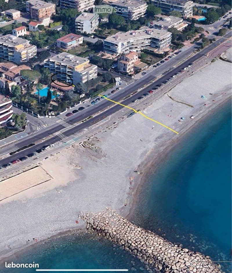 aerial view of beachfront residential building, swimming pool, yellow line indicating distance to beach, multiple buildings, greenery