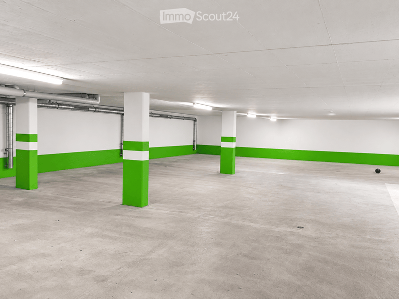 {"visible_features": ["Garage"], "type": "Garage", "objects": [], "description": "Empty underground garage with concrete floors, white walls, green accent stripes, and support pillars.", "localized_descriptions": {"EN": "Empty underground garage with conc