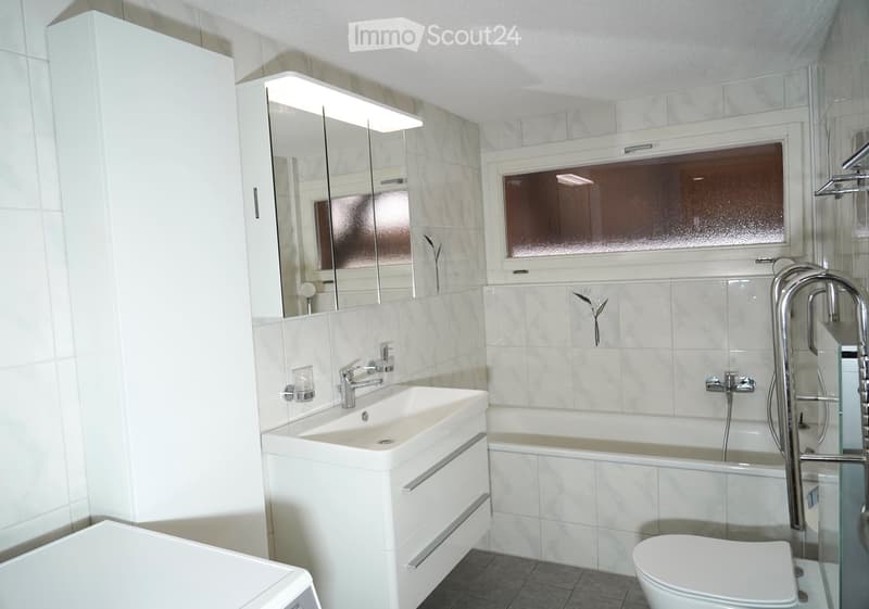 modern, white tiles, bathtub, white sink, silver faucet, window, mirror, cabinets, toilet, washing machine