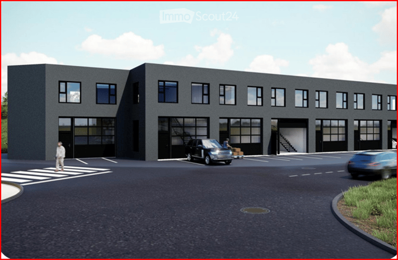 Modern industrial-style building with large garage doors, multiple windows, and a paved parking area.