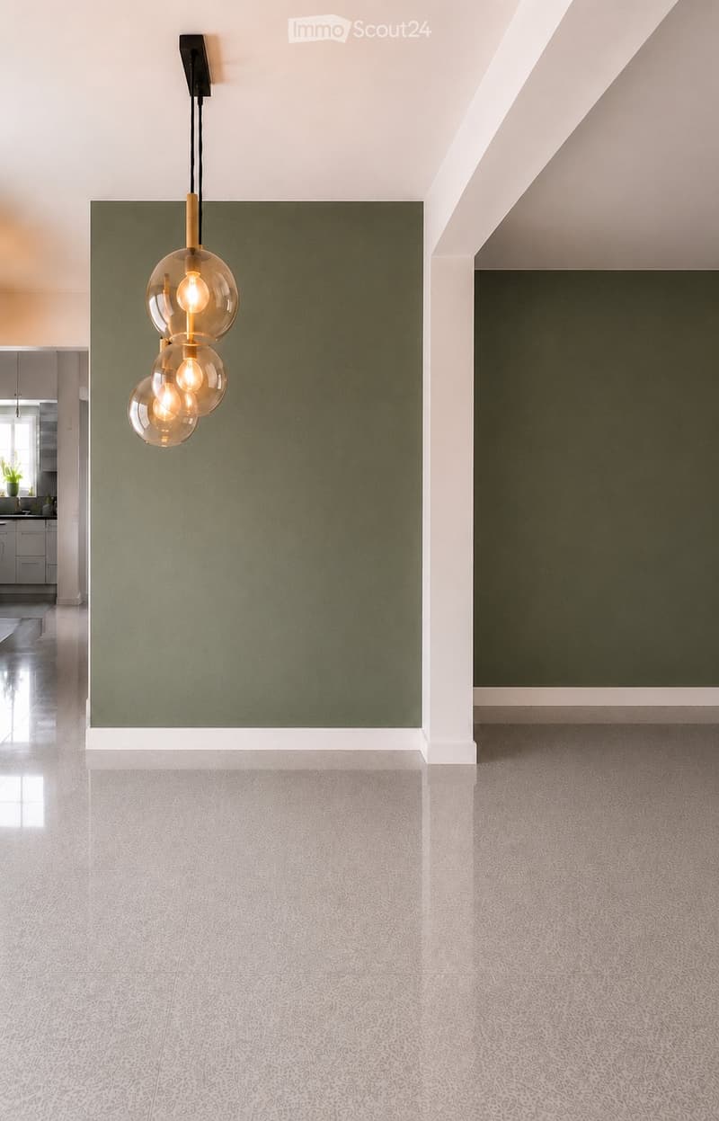 Modern hallway with green accent wall, white trim, and patterned gray tile flooring. A pendant light fixture with three glass globes hangs from the ceiling.