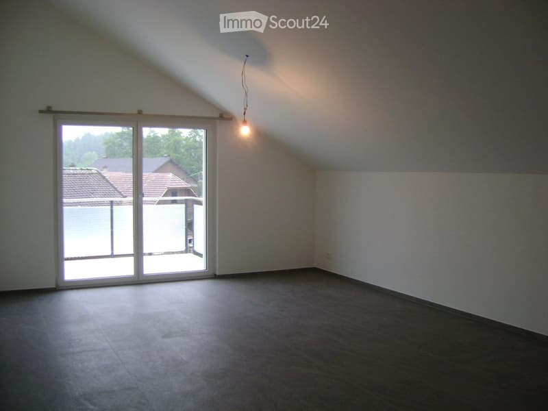 Empty room with tiled floor, white walls, and large sliding glass door leading to outdoor area.