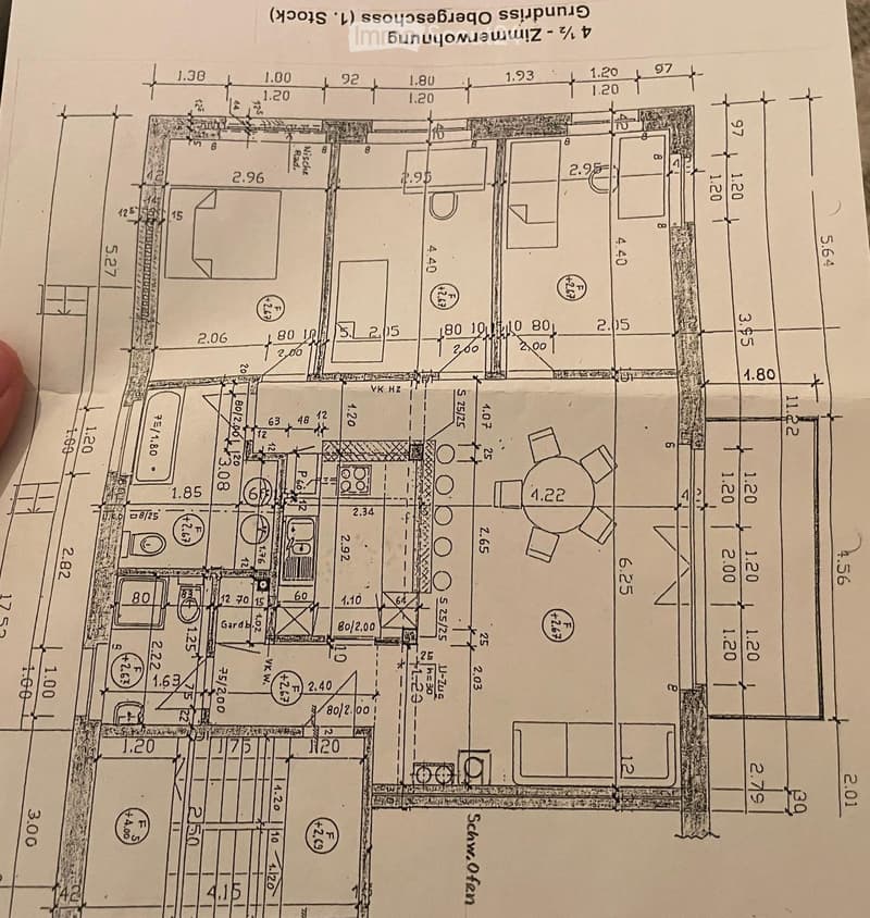 Floor plan of a residential space with labeled dimensions, including rooms, hallways, and a garden area.