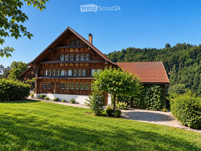Traditional wooden house with a pitched roof, surrounded by a well-maintained lawn and garden, with trees and hills in the background.