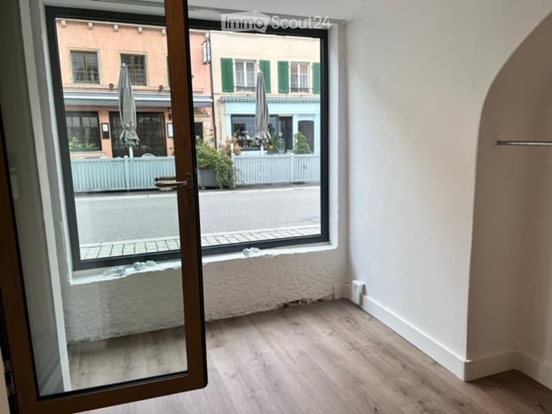 large window, glass door, wooden floor, clear view of the outside