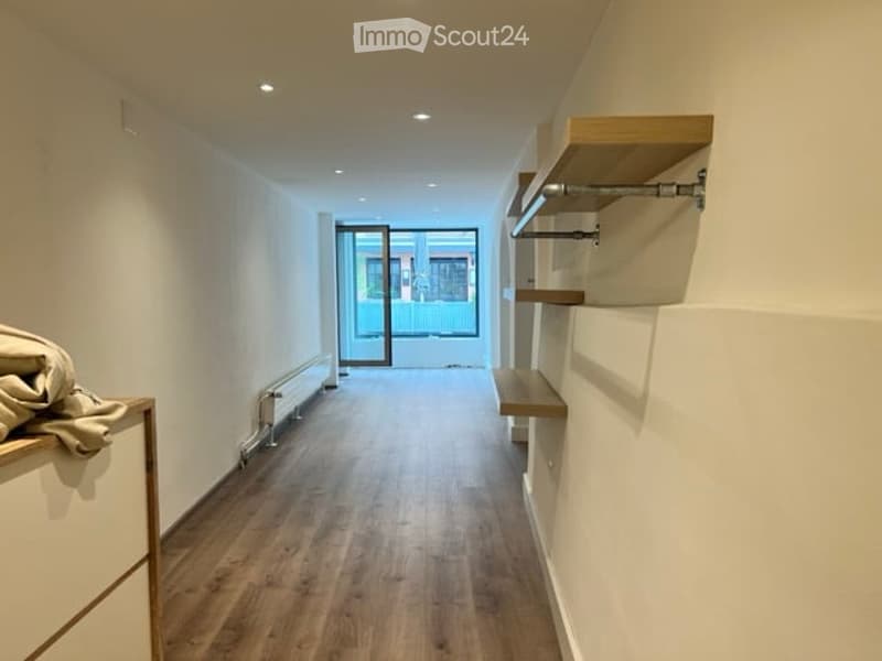 wooden floors, white walls, wall shelves, glass door