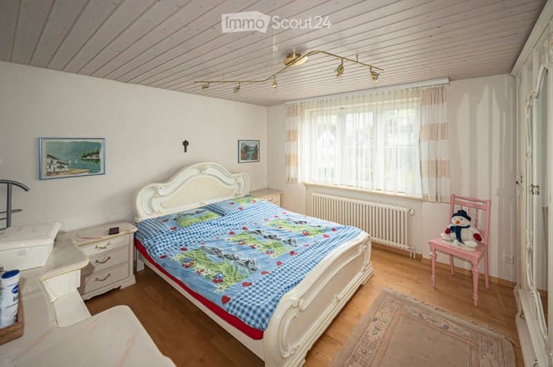 {"visible_features": [],    "type": "Room",    "description": "Bedroom with bed, nightstands, radiator, window, chair, rug, and paintings on the wall",    "localized_descriptions":        {        "EN": "Bedroom with bed, nightstands, radiator, windo