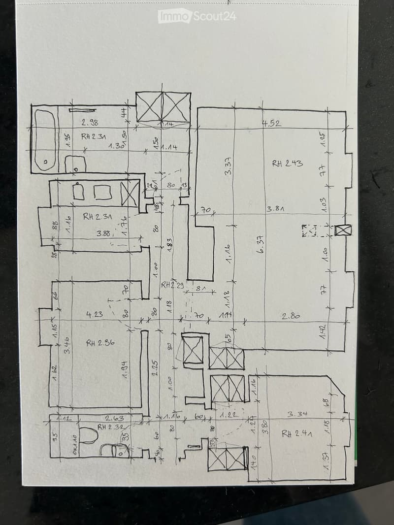 Hand-drawn floor plan showing multiple rooms with labeled dimensions and room heights. Includes living area, bedrooms, bathrooms, and kitchen.