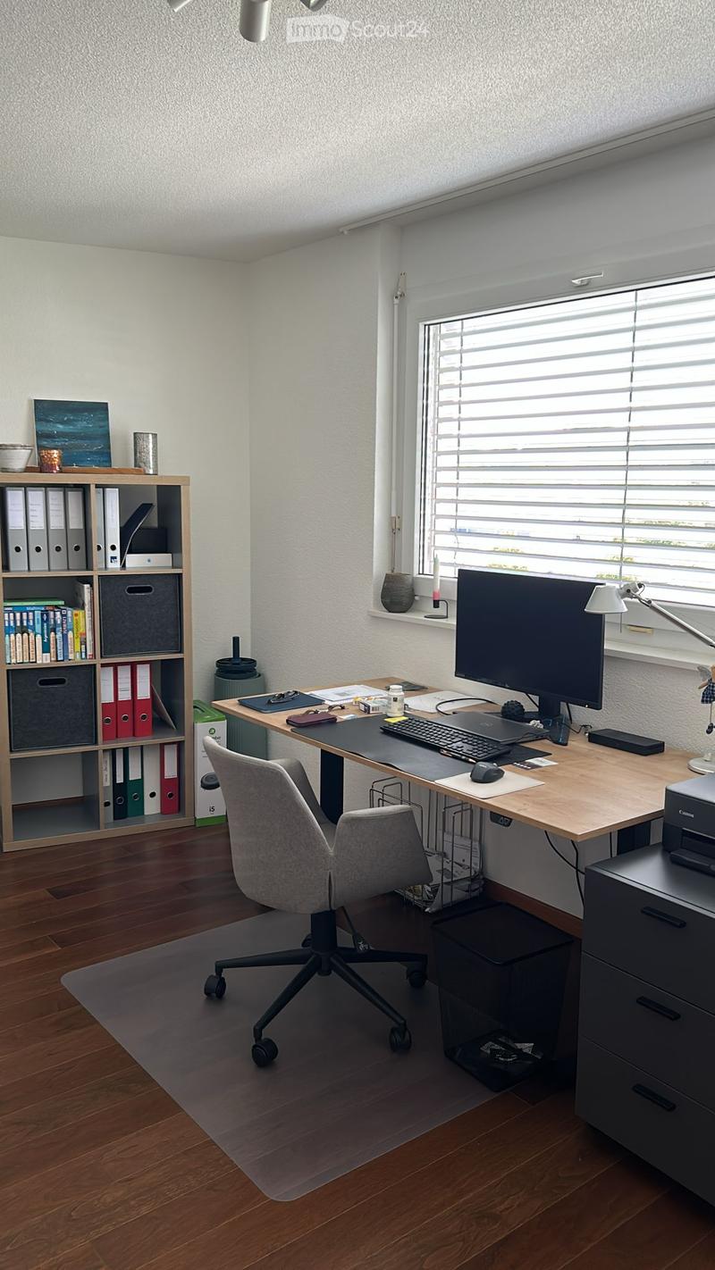 {"visible_features": ["Balcony / Terrace"], "type": "Home office", "description": "Spacious home office with large window, wooden desk, computer setup, shelving unit, and office chair"}
