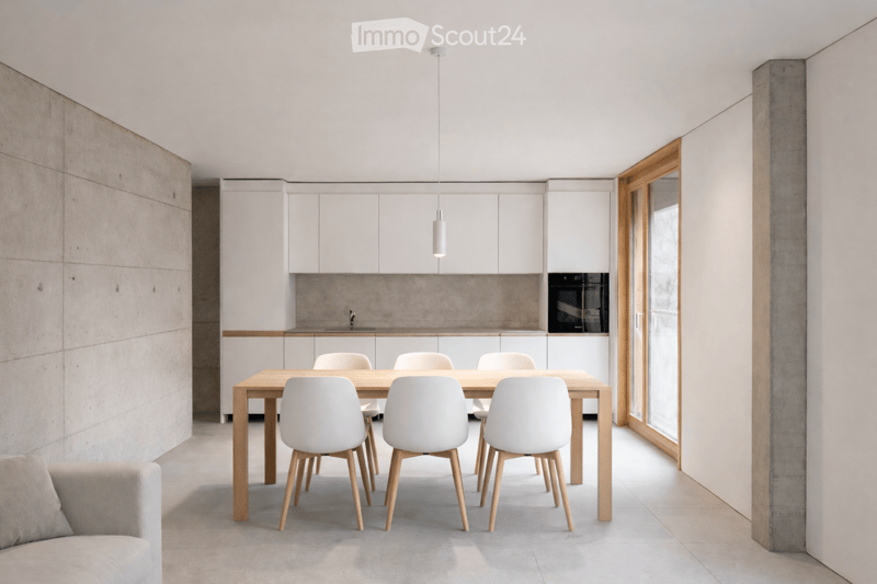 white kitchen cabinets, gray floor, rectangular wooden dining table, white chairs, pendant light, gray wall