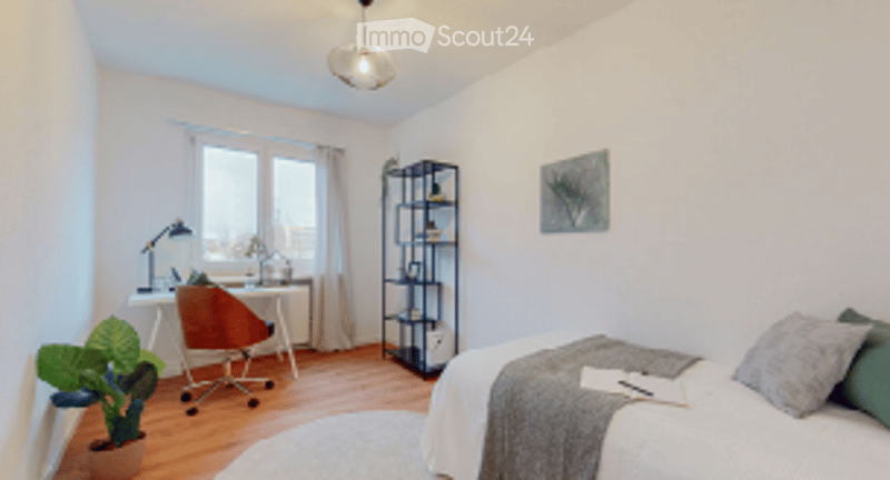 Modern bedroom with a bed, nightstand, desk, chair, lamp, plant, and shelf. The room features large windows and a cozy, minimalist design.