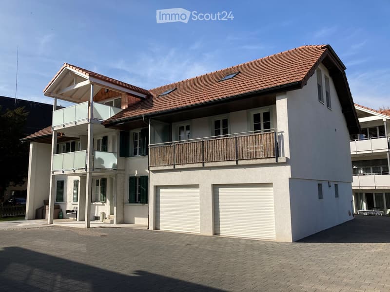 2 story house, white exterior, brown roof, 2 garages, balcony