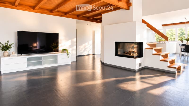 Modern living room with a sleek black television on a white cabinet, a built-in fireplace, and a staircase leading to another level. The space features a polished dark floor and white walls with wooden beams on the ceiling.