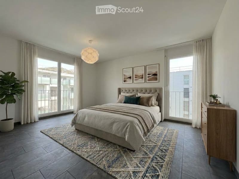 Modern bedroom with large windows, grey bedding, wooden nightstand, dresser, and decorative rug.