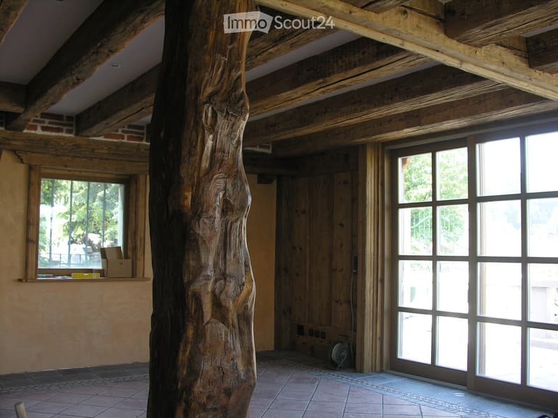 wooden ceiling, wooden walls, large glass doors, window with view of outside