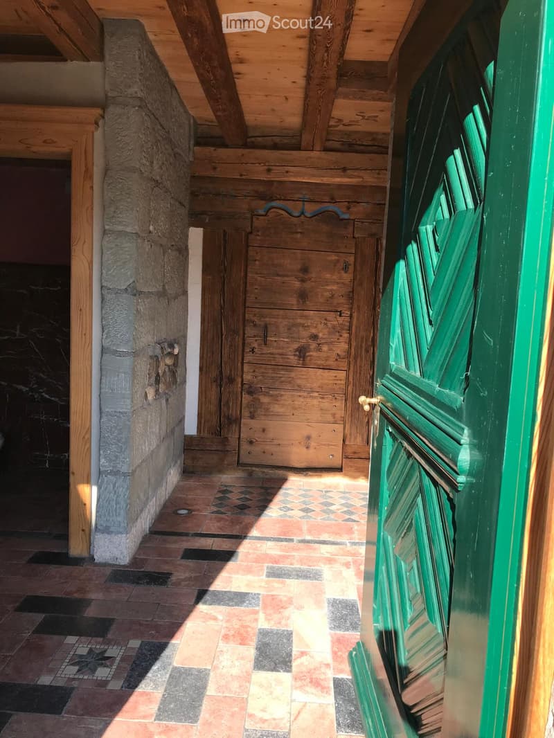 wooden ceiling, stone wall, tiled floor, wooden door, sunlight