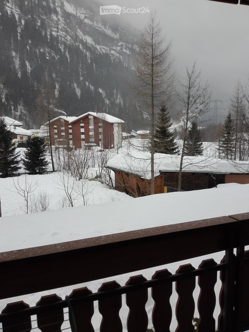 Snowy landscape, building, mountain range, balcony railing, deciduous trees, pine trees