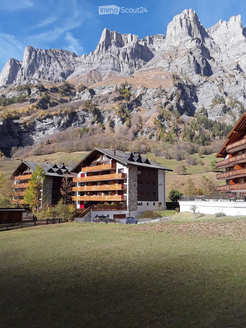 apartment building, mountains, car parking, balconies