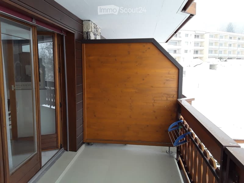 wooden railings, large glass door, brown wooden wall, wooden floor