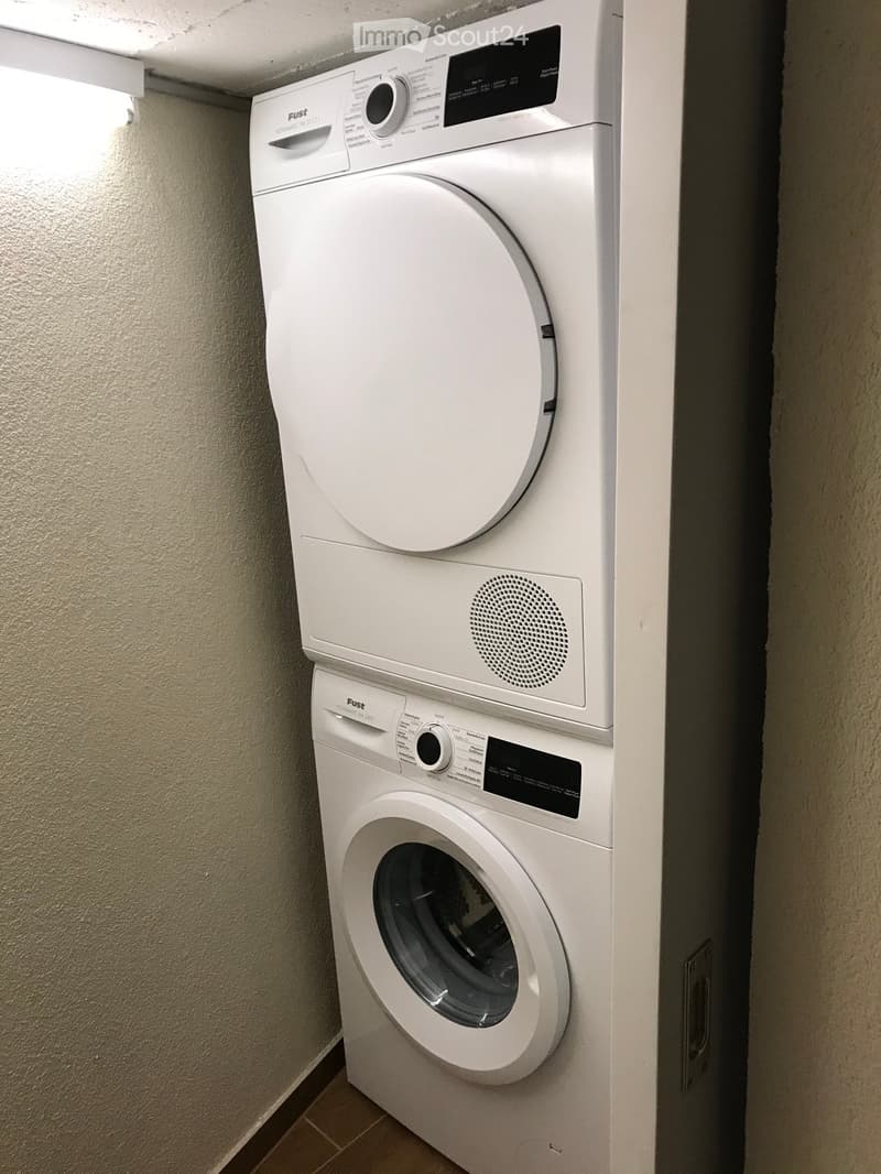 {"visible_features": ["Private washing machine", "Dishwasher"],    "type": "Laundry room",    "description": "stacked washing machine and dryer, both white",    "localized_descriptions":        {        "EN": "stacked washing machine and dryer, both