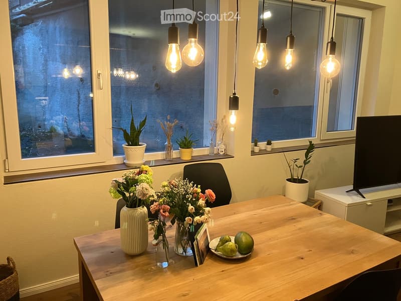 {"visible_features": [],    "type": "Room",    "description": "dining room, wooden table, flowers, fruits, hanging lights, chairs, large windows, plants",    "localized_descriptions":        {        "EN": "Dining room: wooden table, flowers, fruits,