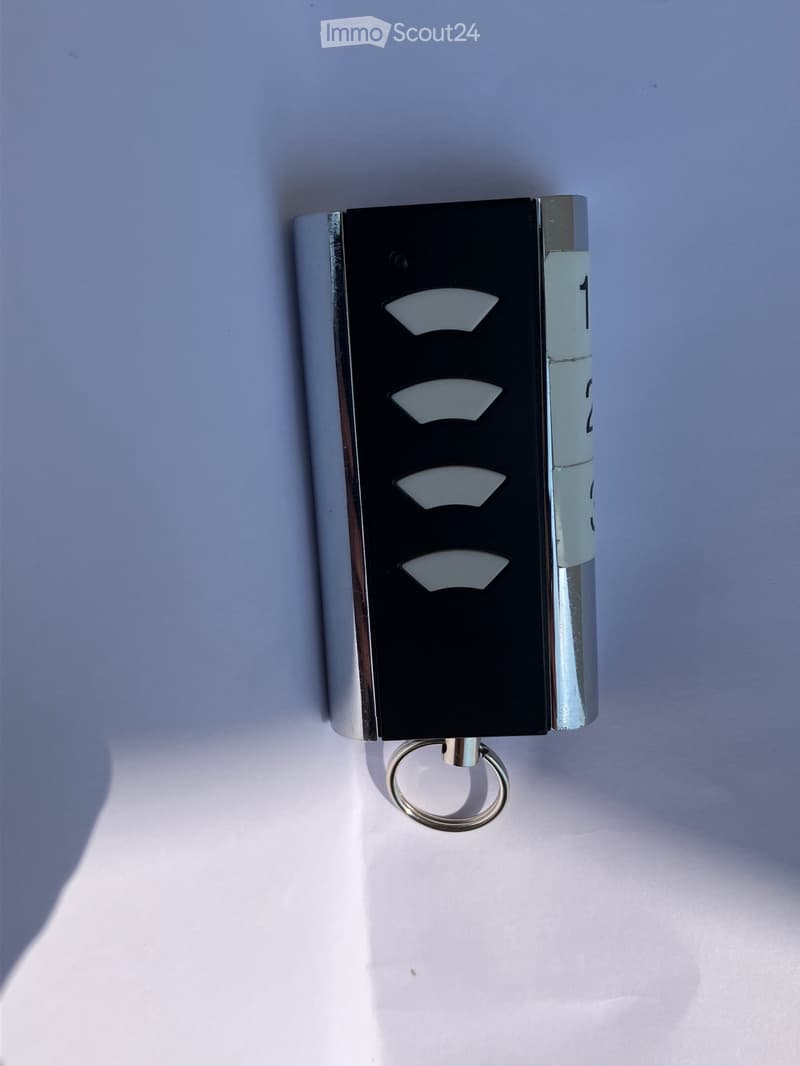 {"visible_features": [], "type": "Device", "description": "Key fob with three buttons, number 1, 2, and 3, attached to a key ring"}
