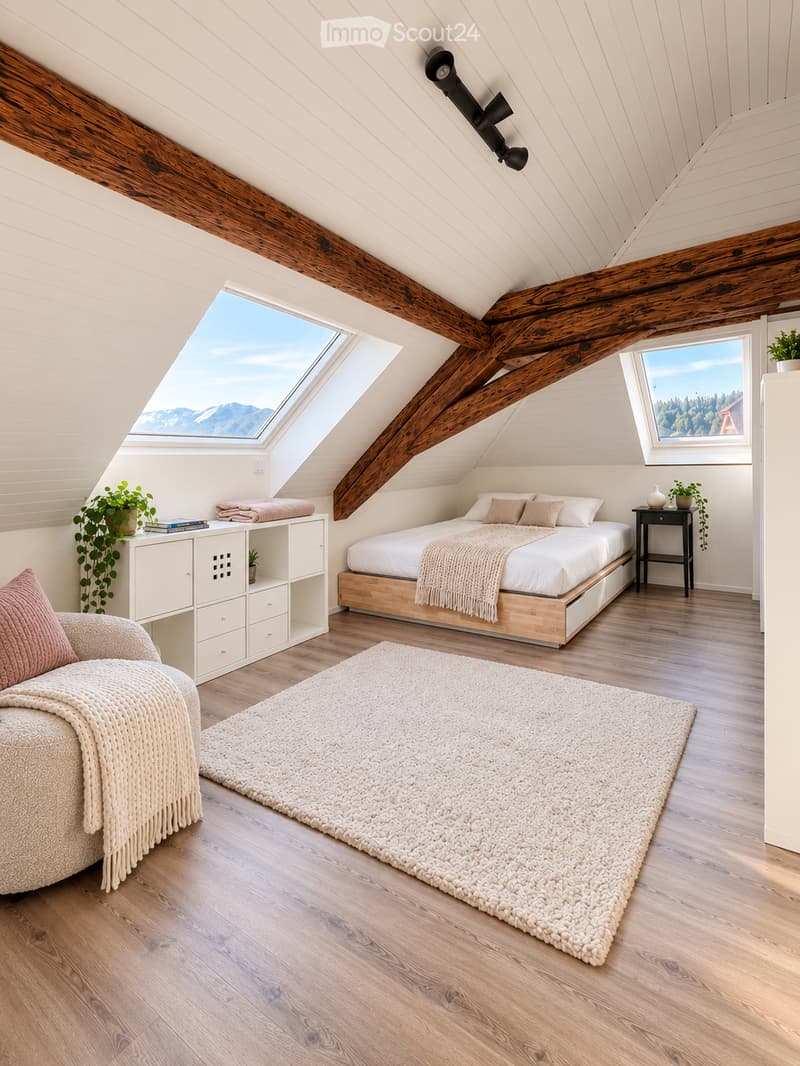 Cozy attic bedroom with wooden beams, skylight, and large window overlooking mountains. Features a bed, sofa, nightstand, and storage cabinet.