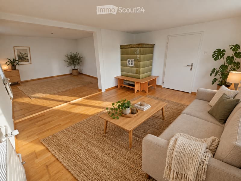 Bright living room with wooden flooring, a beige sofa with throw blanket, wooden coffee table with plant and books, bench, table lamp, and potted plants.