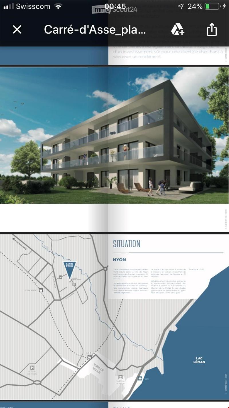 Modern multi-story residential building with balconies, surrounded by greenery and outdoor seating.