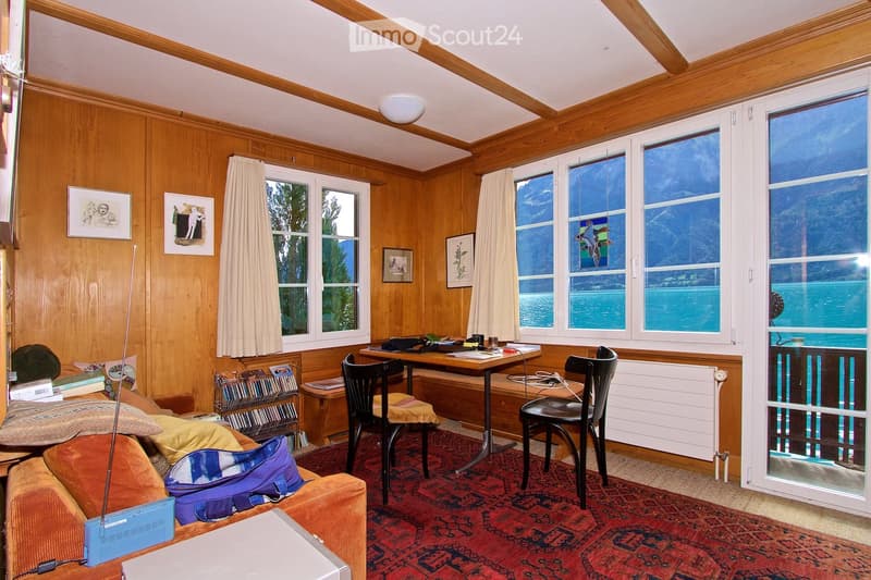 {"type": "Furnished Room", "objects": ["sofa", "table", "chair", "laptop", "books", "radiator", "curtain", "picture frame", "radiator", "laptop", "laptop", "laptop", "laptop", "laptop", "laptop", "laptop", "laptop", "laptop", "laptop", "laptop", "laptop",