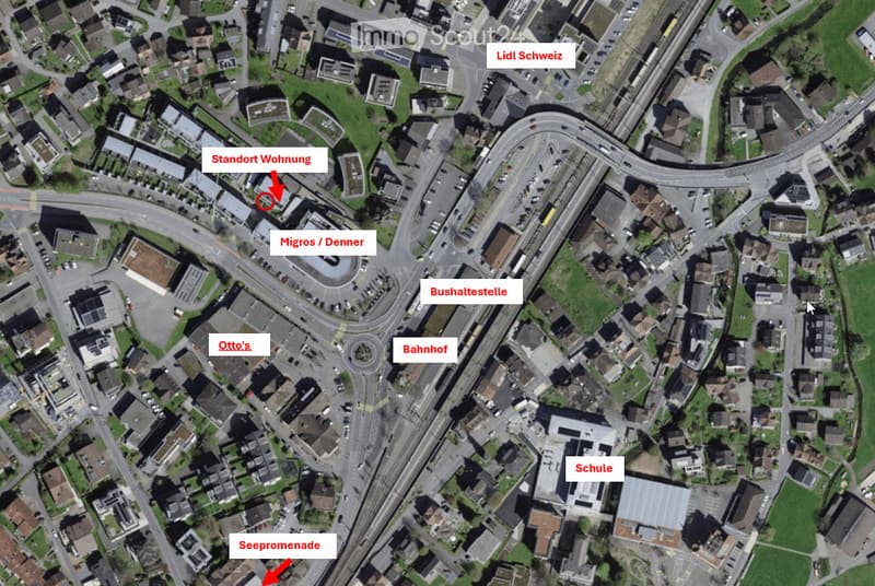 Aerial view of a residential area with labeled points of interest including 'Standort Wohnung' (location of the apartment), 'See promenade', 'Bahnhof' (train station), 'Bushaltestelle' (bus stop), 'Schule' (school), 'Lidl Schweiz', 'Otto's', and 'Migros/D
