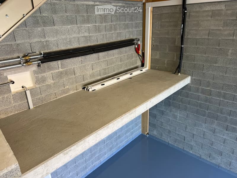 {"type": "Garage", "objects": [], "description": "Garage with a concrete floor, grey brick walls, and a wooden shelf with pipes and fittings.", "localized_descriptions": {"EN": "Garage with a concrete floor, grey brick walls, and a wooden shelf with pipes