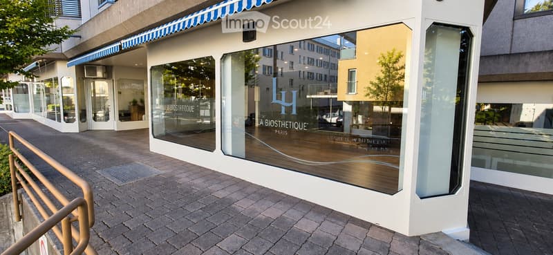 Modern storefront with large glass windows and a striped awning, displaying the sign "LA BIOSTHETIQUE PARIS".