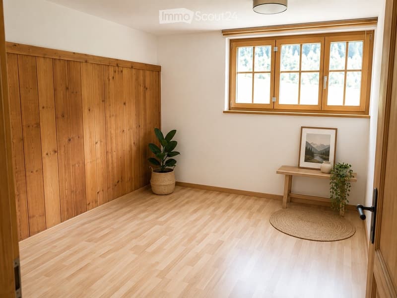 A modern hallway with light wooden flooring, white walls, and a large window. Features include a small wooden table with a picture frame, a potted plant, and a round woven rug.