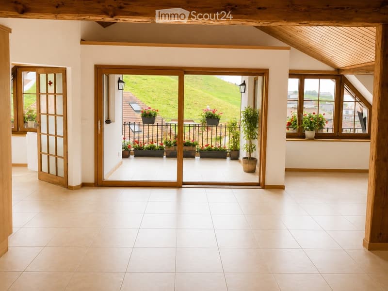 Bright, open room with wooden beams, large sliding glass doors leading to a balcony, tiled floor, and white walls.