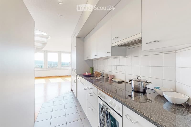 Modern kitchen with white cabinets, granite countertop, stainless steel appliances, and various kitchen items including a pot, bowls, and a towel.