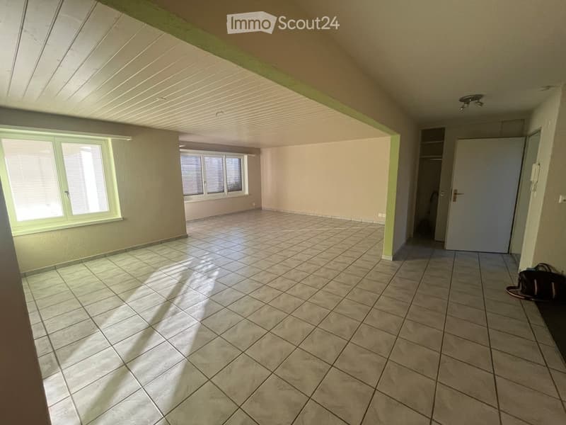 Empty room with tiled floor, large windows, and a closet area. No furniture or equipment visible.