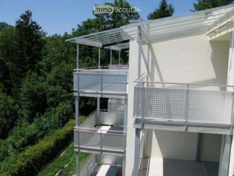 White building, multi-story apartment, metal railings, balconies on the front