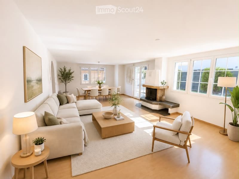 Bright, modern living room with white walls, wooden flooring, large windows, a sectional sofa, coffee table, armchair, side table, floor lamp, fireplace, dining area with table and chairs, and decorative plants.